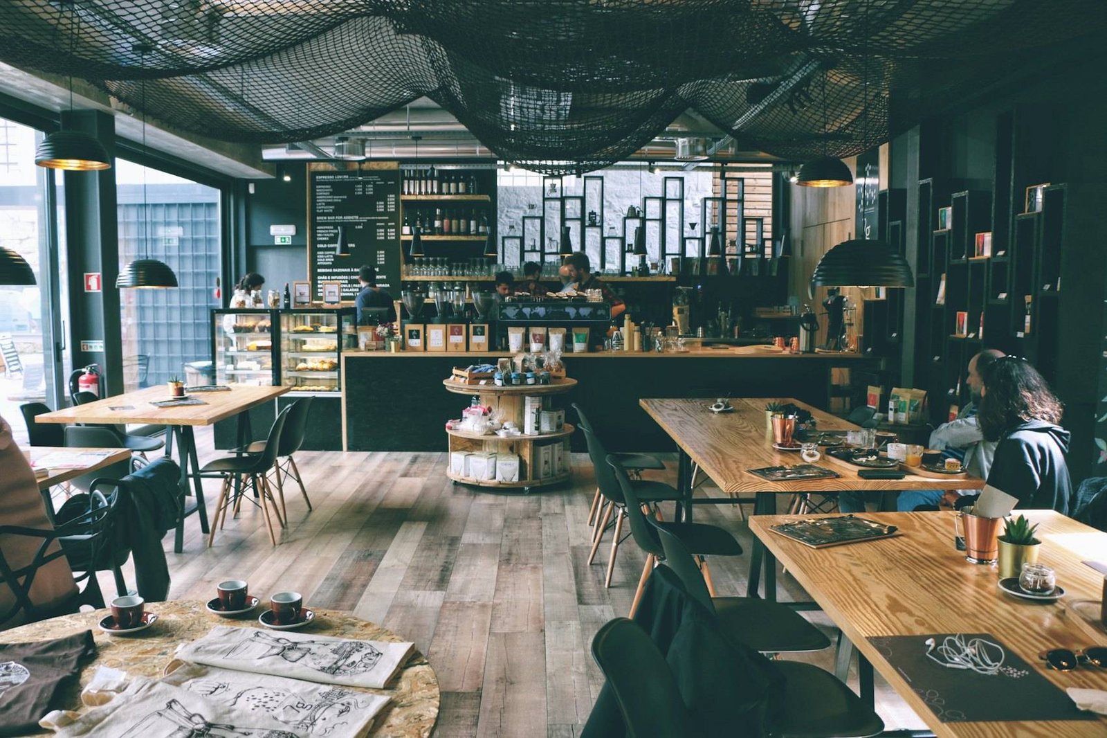 Long communal table and bar seating inside the café