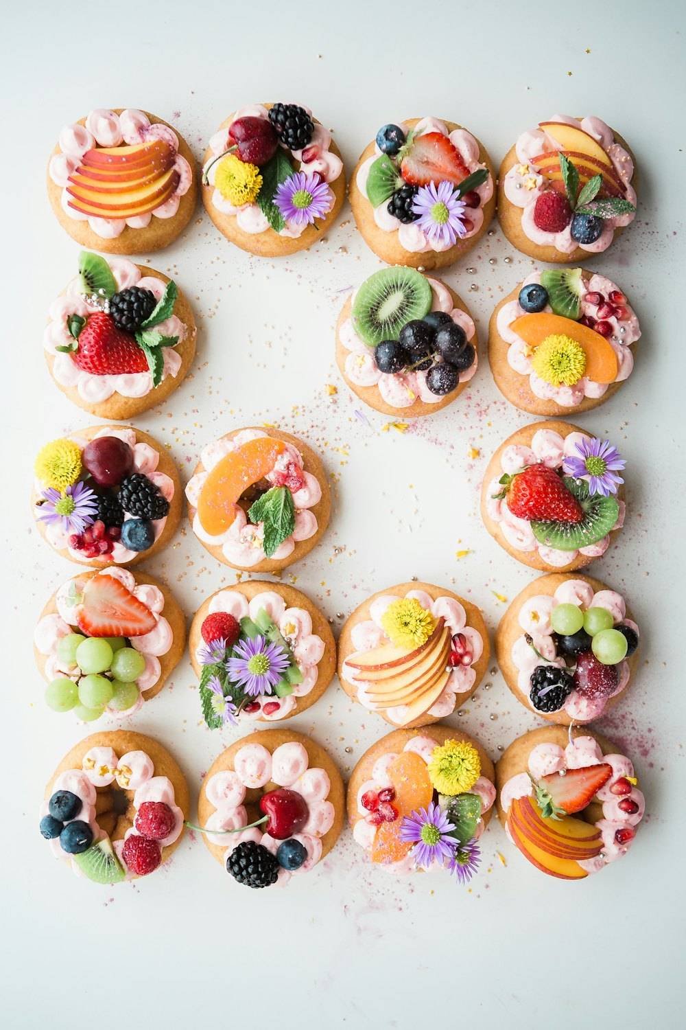 Rows of small seasonal fruit tarts
